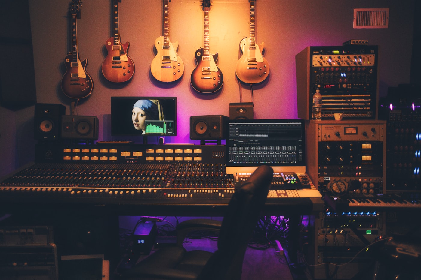 The Nova sound room, guitars lining the wall above a mixing desk