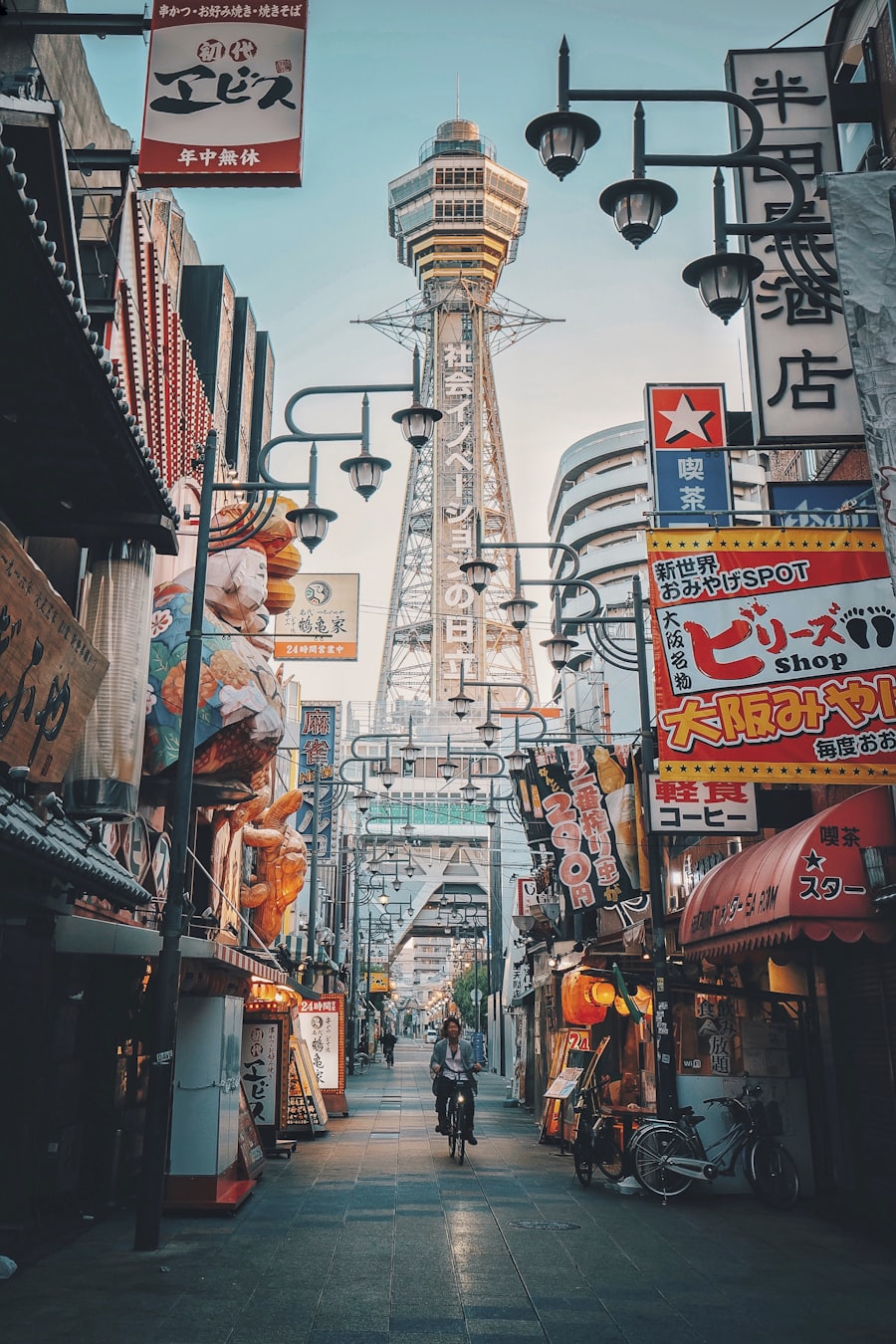 A lantern-lit Ōsaka street beneath Tsutenkaku tower